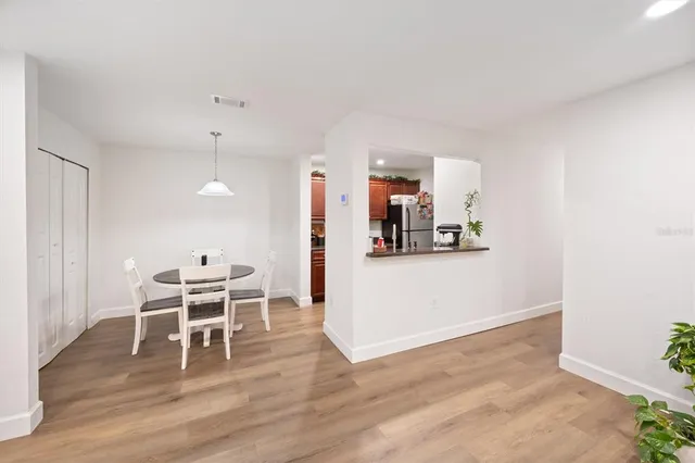 a view of a kitchen with dining room and wooden floor
