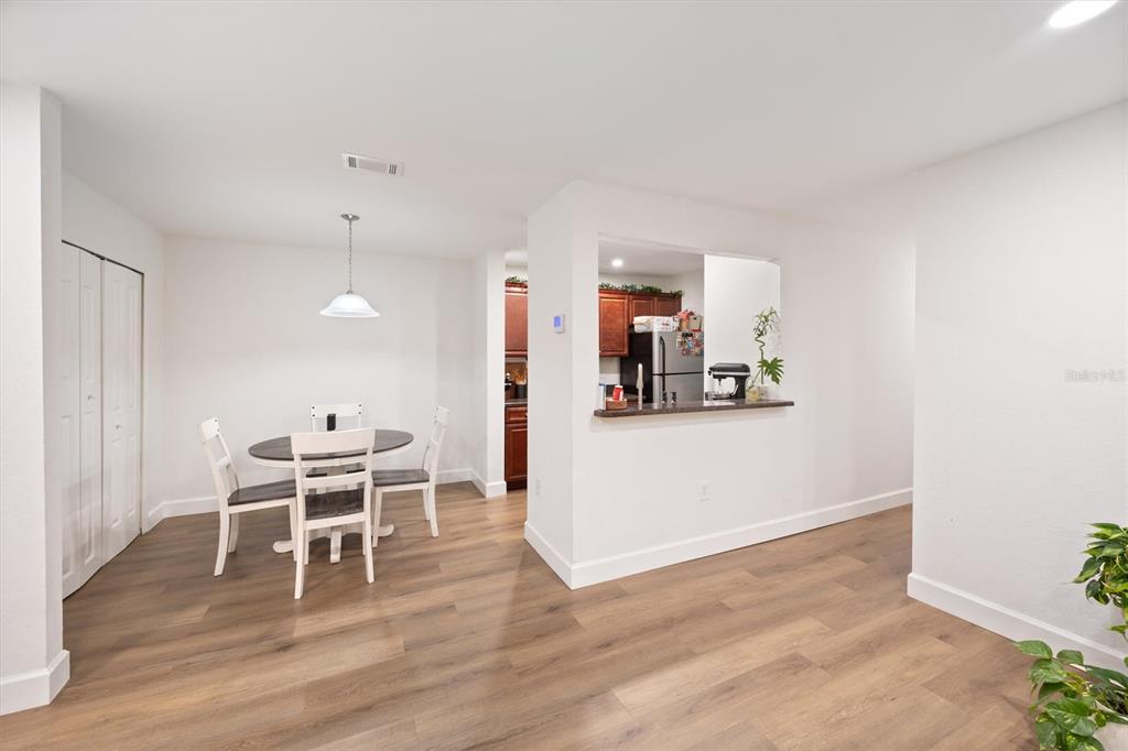 3705 Southwest 27th Street, Unit 913 Gainesville, FL 32608 - Photo 27 of 50 a view of a kitchen with dining room and wooden floor