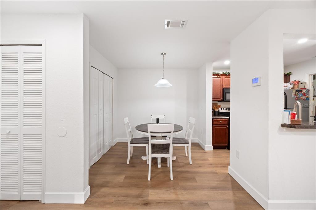 3705 Southwest 27th Street, Unit 913 Gainesville, FL 32608 - Photo 28 of 50 a dining room with furniture and wooden floor