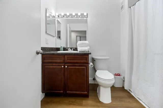 a bathroom with a toilet a sink and mirror