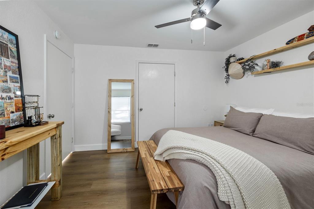 3705 Southwest 27th Street, Unit 913 Gainesville, FL 32608 - Photo 36 of 50 a bedroom with a bed and a chandelier