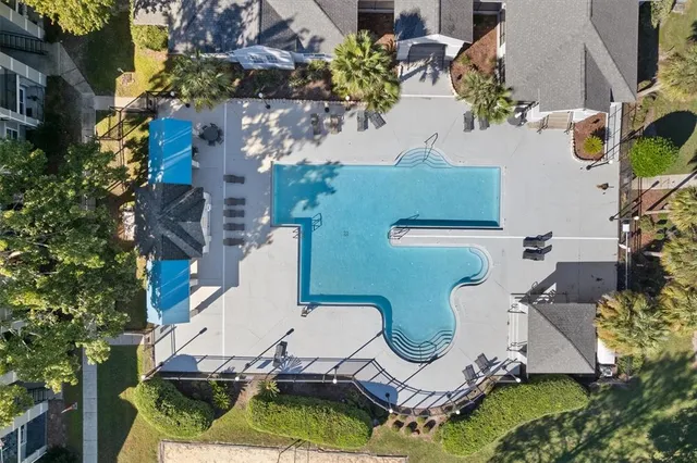an aerial view of a house with outdoor seating and mountain view