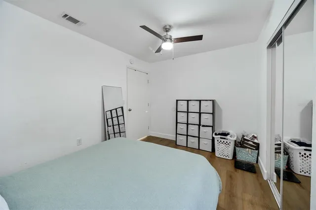 a bedroom with a bed and a flat tv screen on the dresser