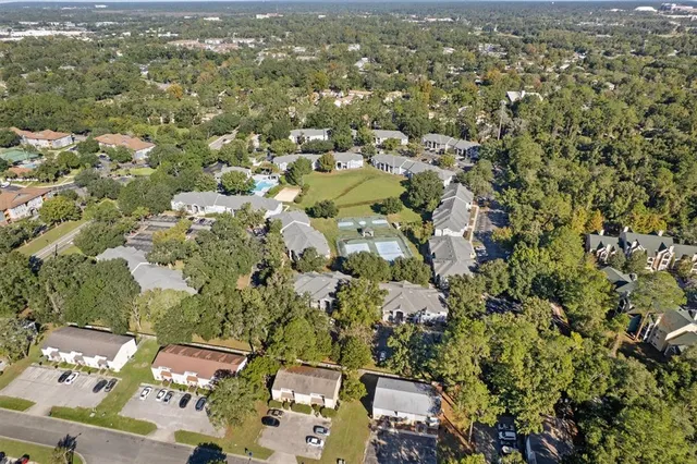 an aerial view of residential houses with city view