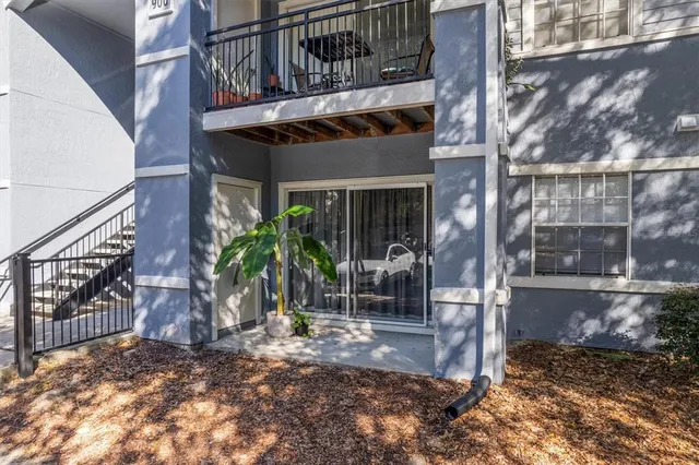 a view of a house with a small yard and wooden floor and fence