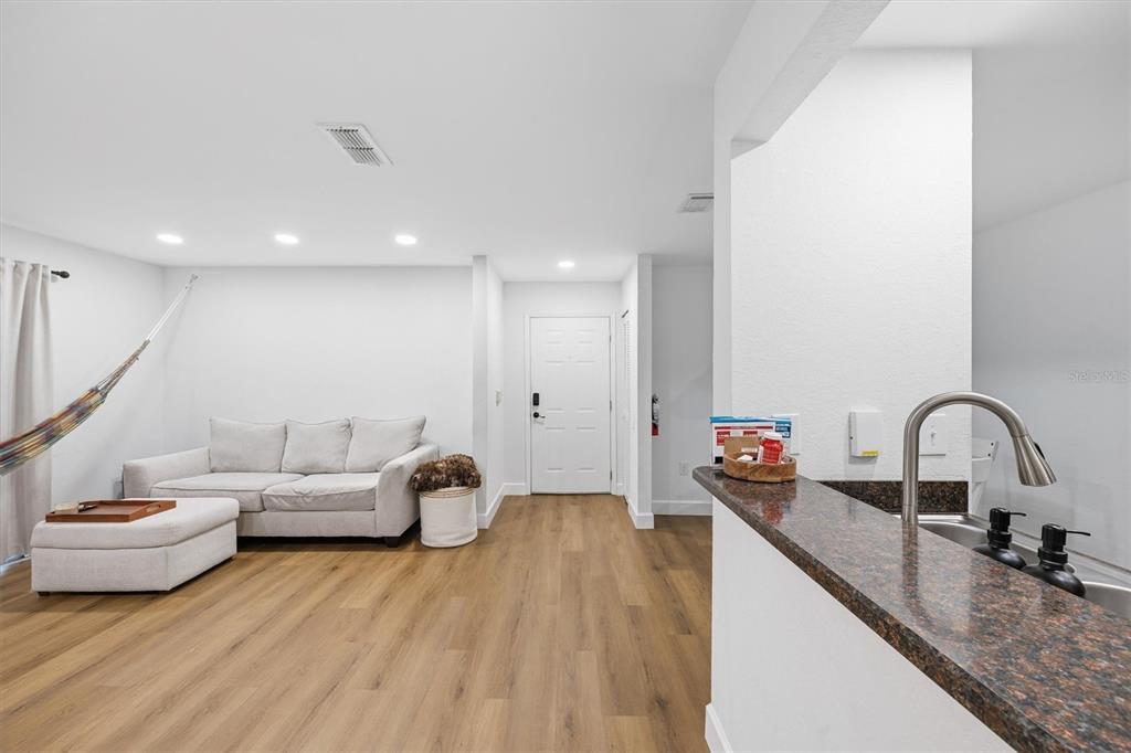 3705 Southwest 27th Street, Unit 913 Gainesville, FL 32608 - Photo 9 of 50 a living room with furniture and a wooden floor