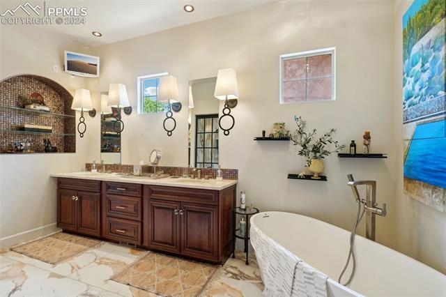 2204 Rocking Horse Court Colorado Springs, CO 80921 - Photo 16 of 50 Bathroom featuring dual vanity, tile patterned floors, and a tub