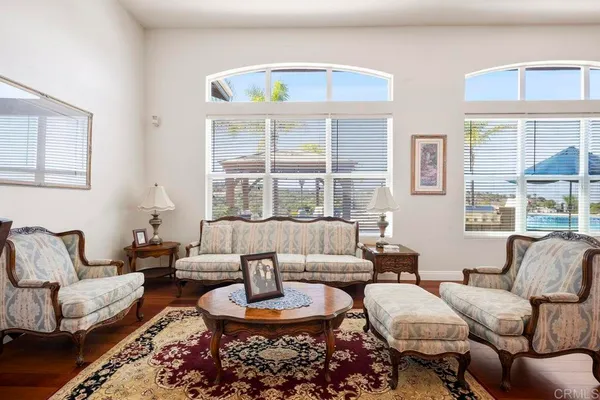 a view of a dining room with furniture a chandelier and wooden floor