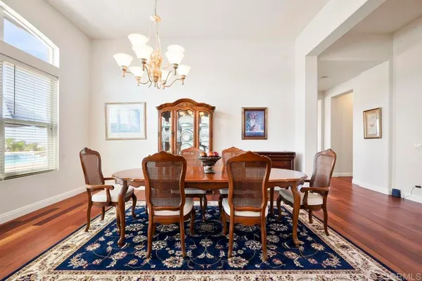 a kitchen with stainless steel appliances granite countertop wooden cabinets a sink a stove a refrigerator and a oven