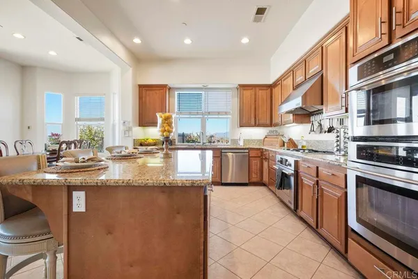 a view of a kitchen counter top a stove and a window