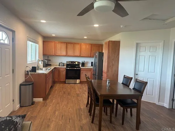 a kitchen with a refrigerator sink and wooden cabinets