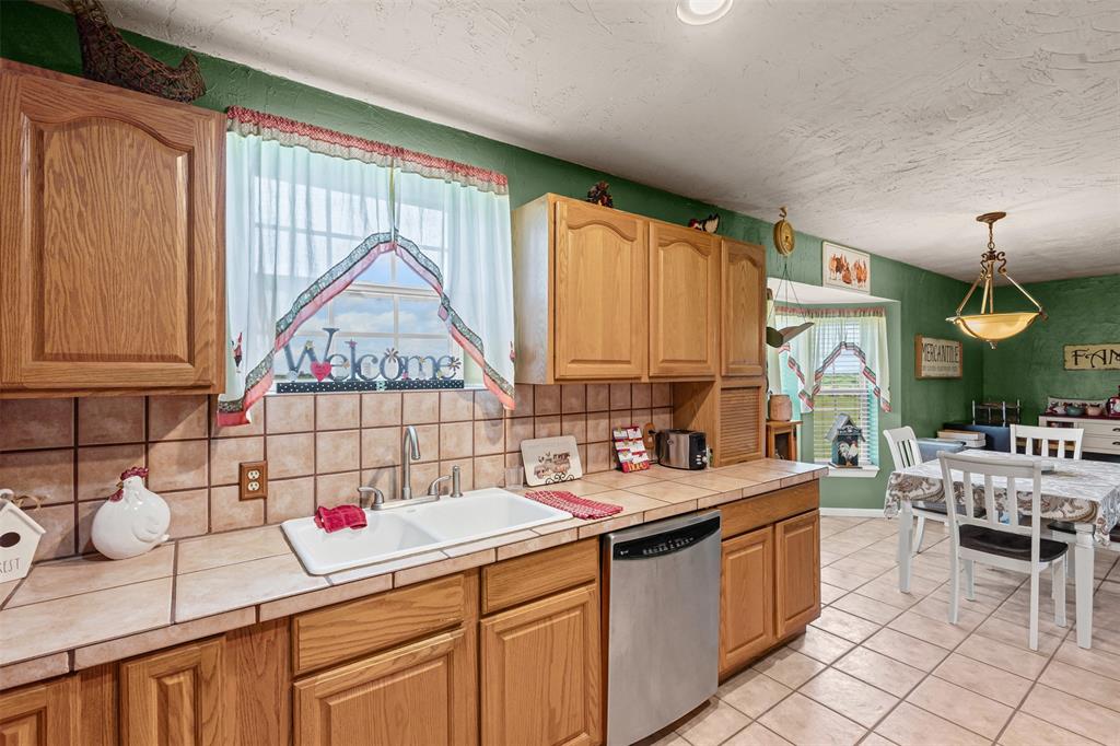 14522 Southwest County Road 4140 Dawson, TX 76639 - Photo 12 of 40 a kitchen that has a sink and a stove