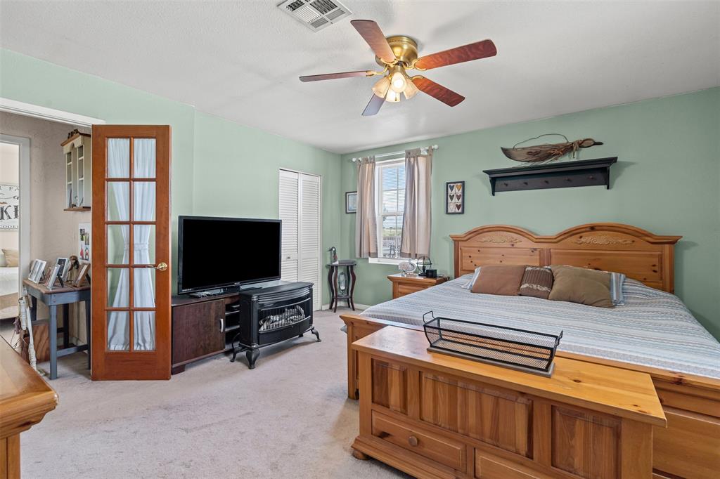 14522 Southwest County Road 4140 Dawson, TX 76639 - Photo 18 of 40 a bedroom with a bed and a flat screen tv