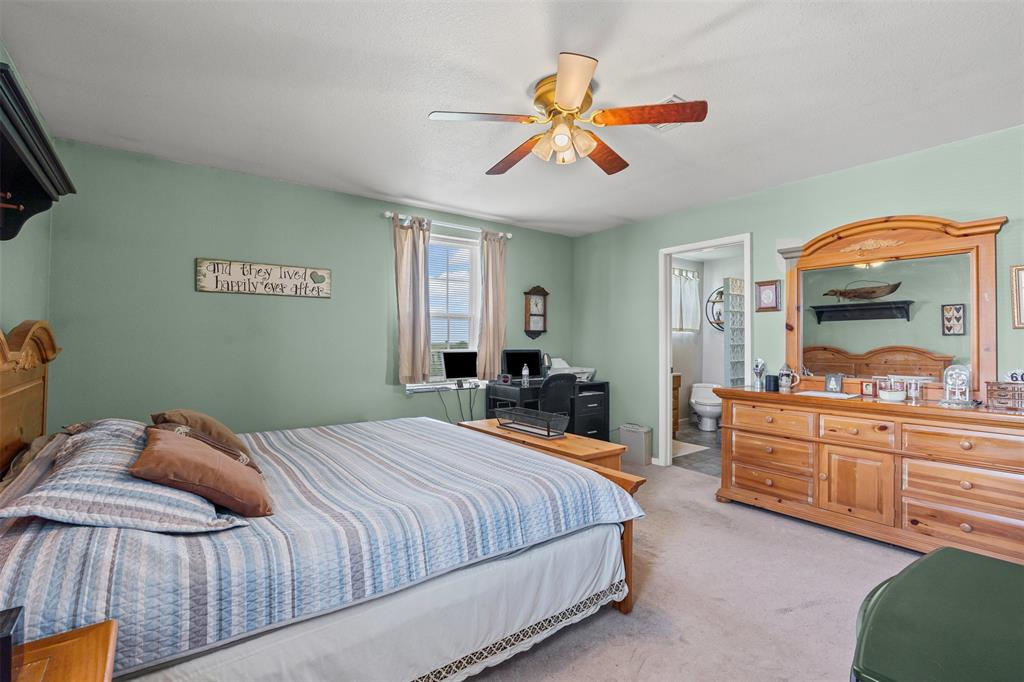 14522 Southwest County Road 4140 Dawson, TX 76639 - Photo 19 of 40 a bedroom with a bed and ceiling fan