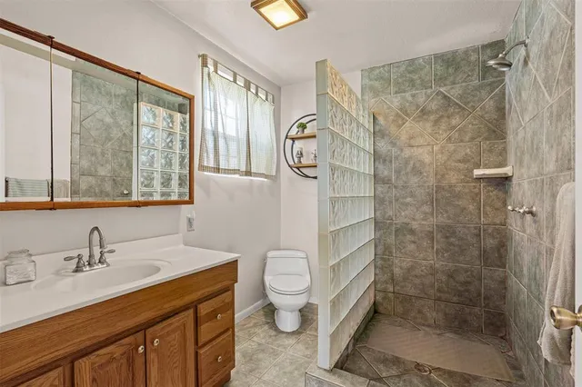 a bathroom with a sink toilet and shower