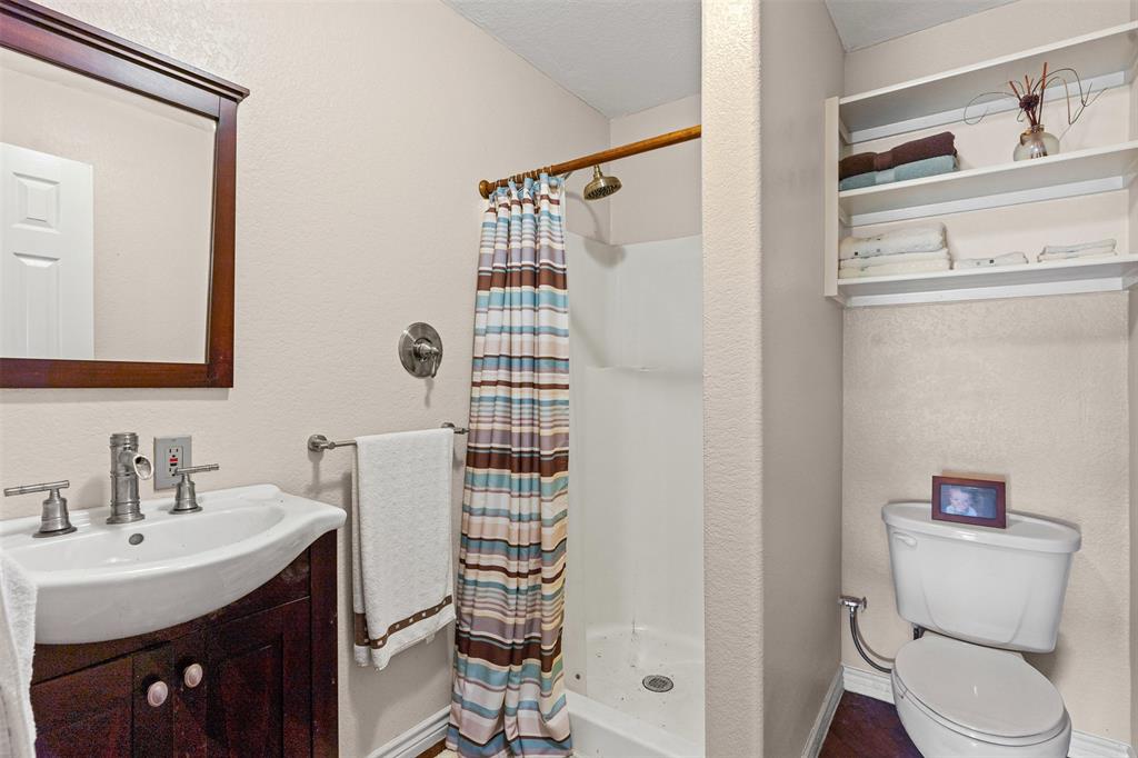 14522 Southwest County Road 4140 Dawson, TX 76639 - Photo 22 of 40 a bathroom with a sink toilet and shower
