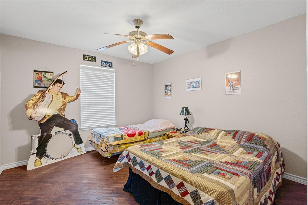 14522 Southwest County Road 4140 Dawson, TX 76639 - Photo 28 of 40 a bedroom with a bed and a chandelier