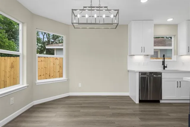 a kitchen with a sink cabinets and window