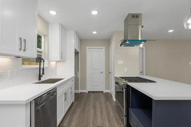 a kitchen with stainless steel appliances granite countertop a sink stove and refrigerator