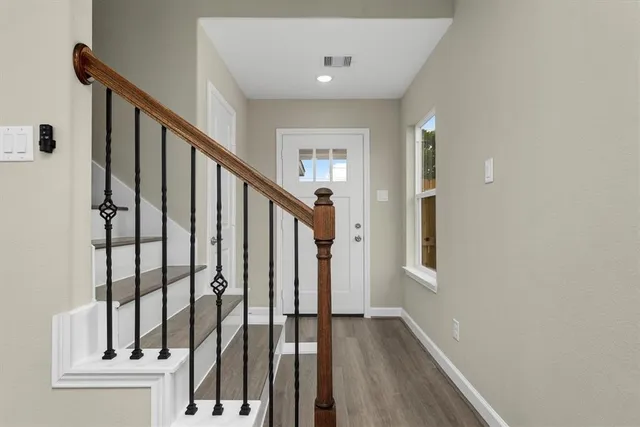 a view of an entryway with wooden floor