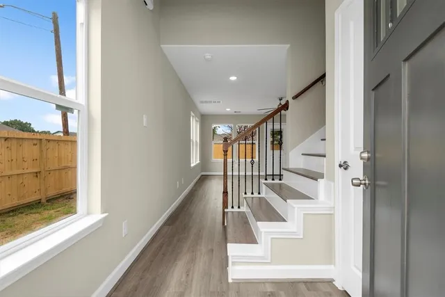 a view of entryway and hall with wooden floor