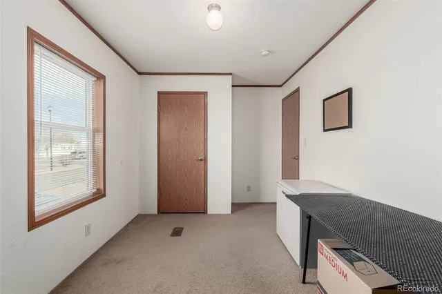 a view of hallway with window and a ceiling fan