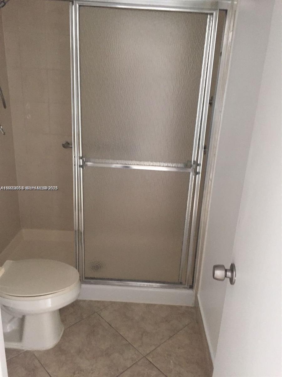 721 North Pine Island Road, Unit 416 Plantation, FL 33324 - Photo 9 of 13 a bathroom with a toilet and a shower