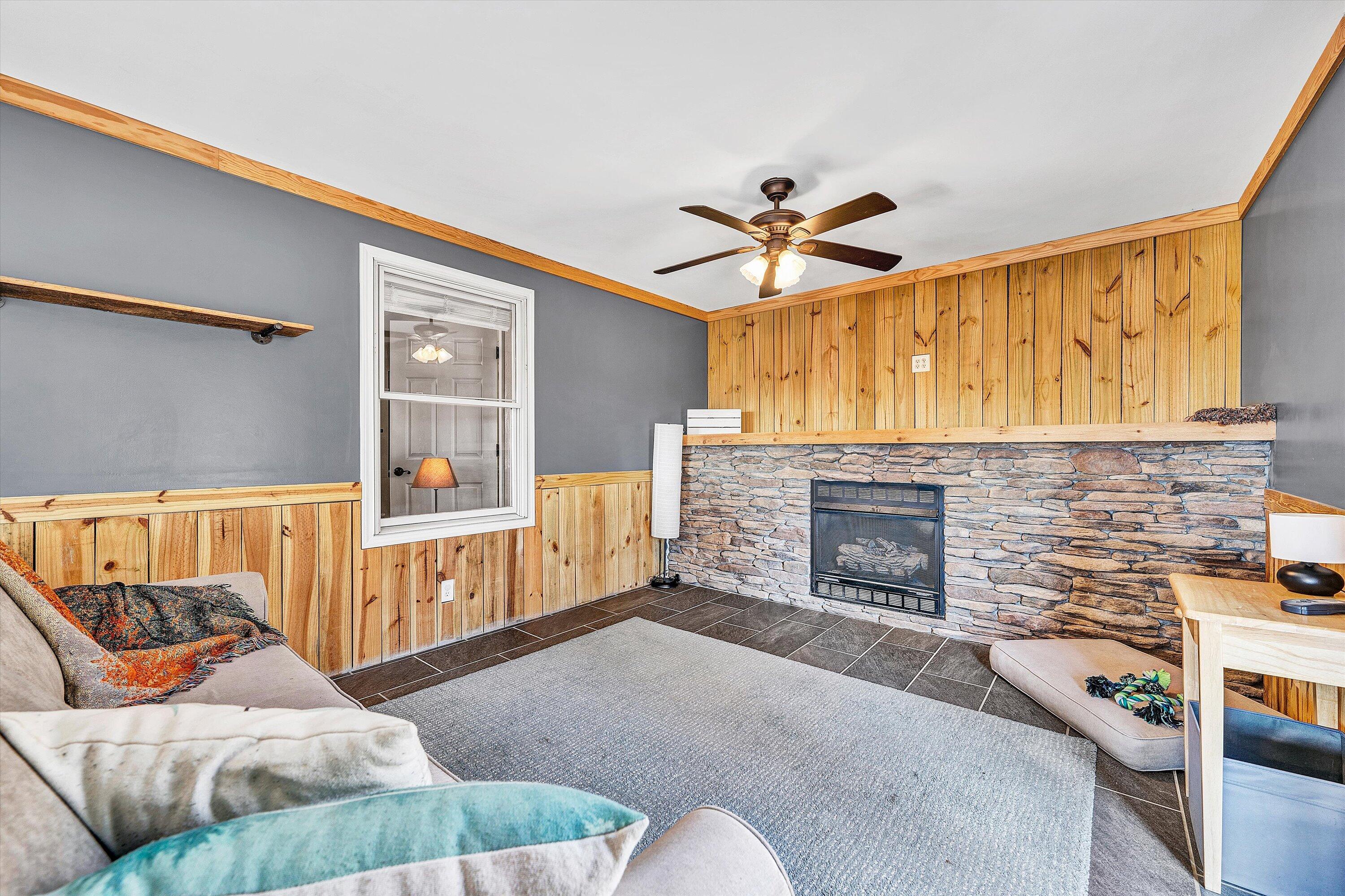 1311 Walnut Shell Drive Vinton, VA 24179 - Photo 15 of 61 a living room with furniture a fireplace and a flat screen tv
