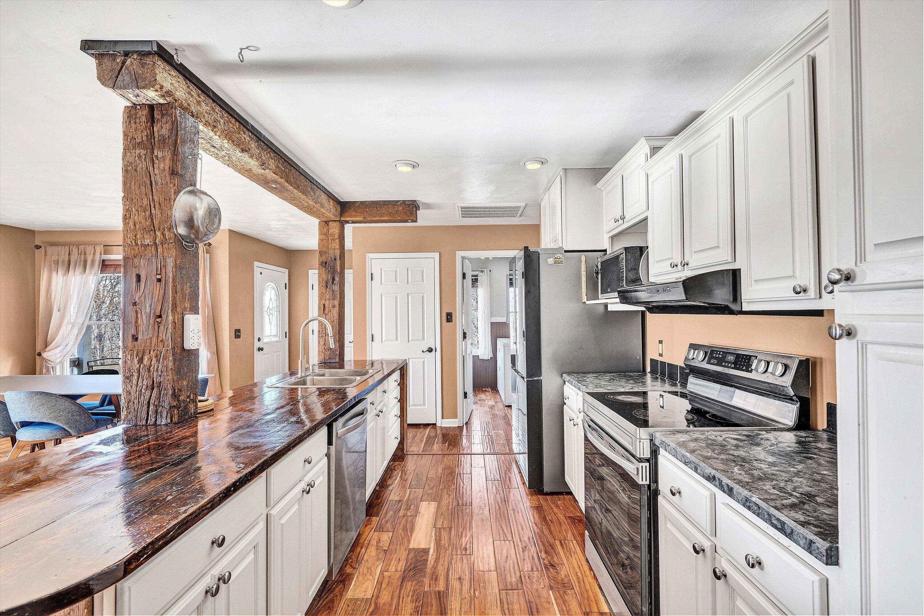 1311 Walnut Shell Drive Vinton, VA 24179 - Photo 18 of 61 a kitchen with stainless steel appliances granite countertop a lot of counter space and wooden floors
