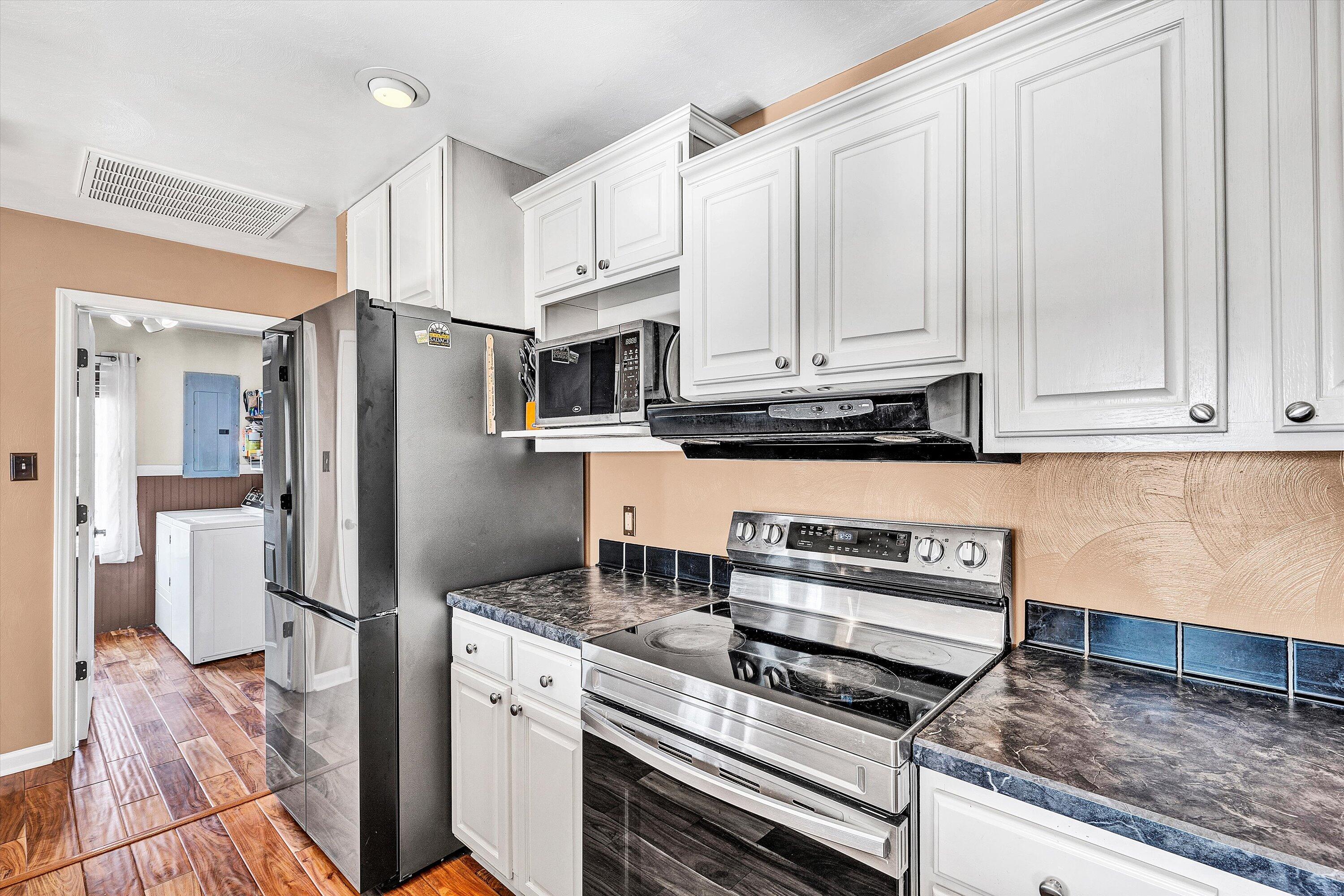 1311 Walnut Shell Drive Vinton, VA 24179 - Photo 19 of 61 a kitchen with stainless steel appliances granite countertop a stove a refrigerator and a white cabinets