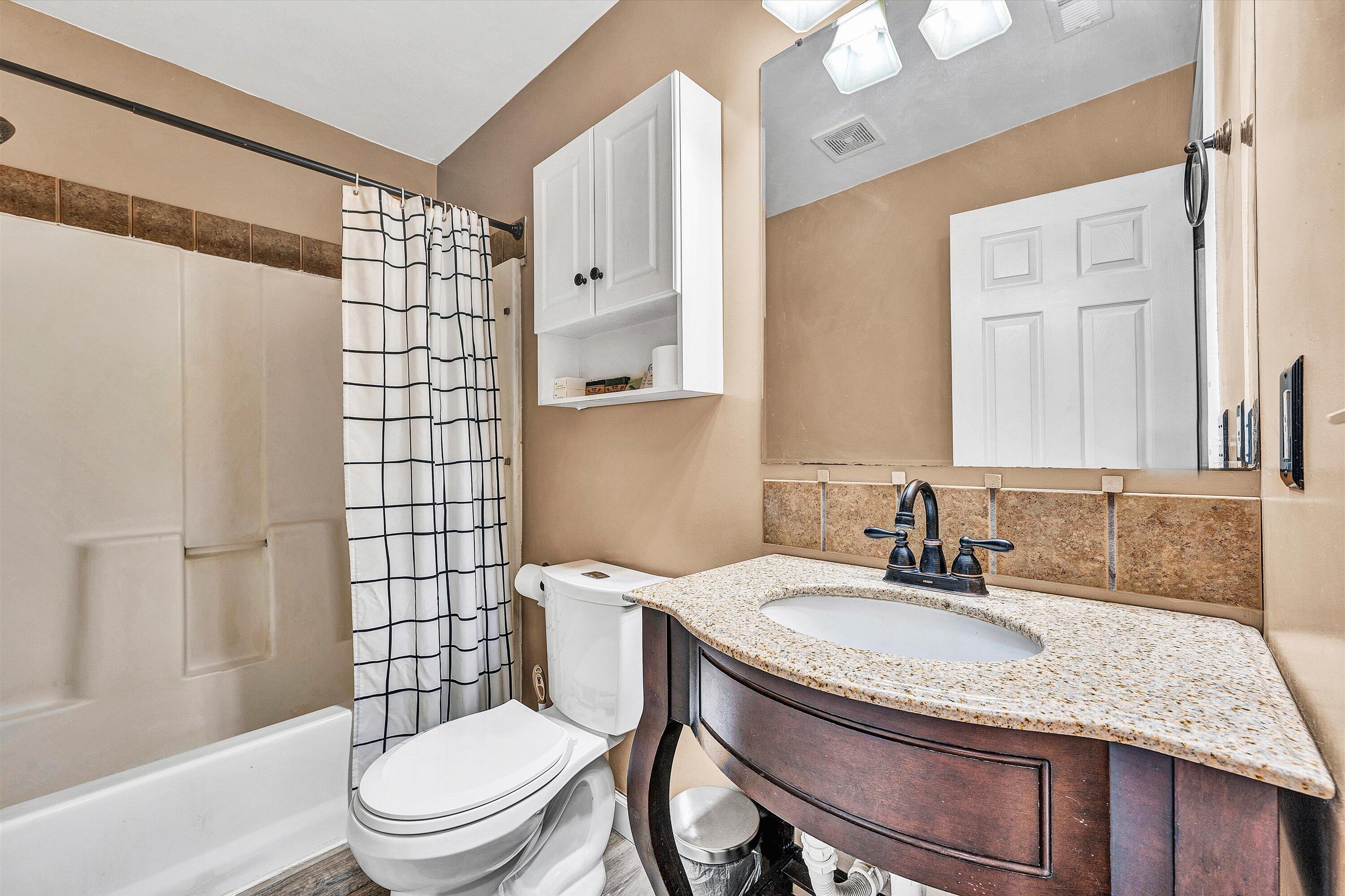 1311 Walnut Shell Drive Vinton, VA 24179 - Photo 30 of 61 a bathroom with a granite countertop sink toilet a mirror and shower