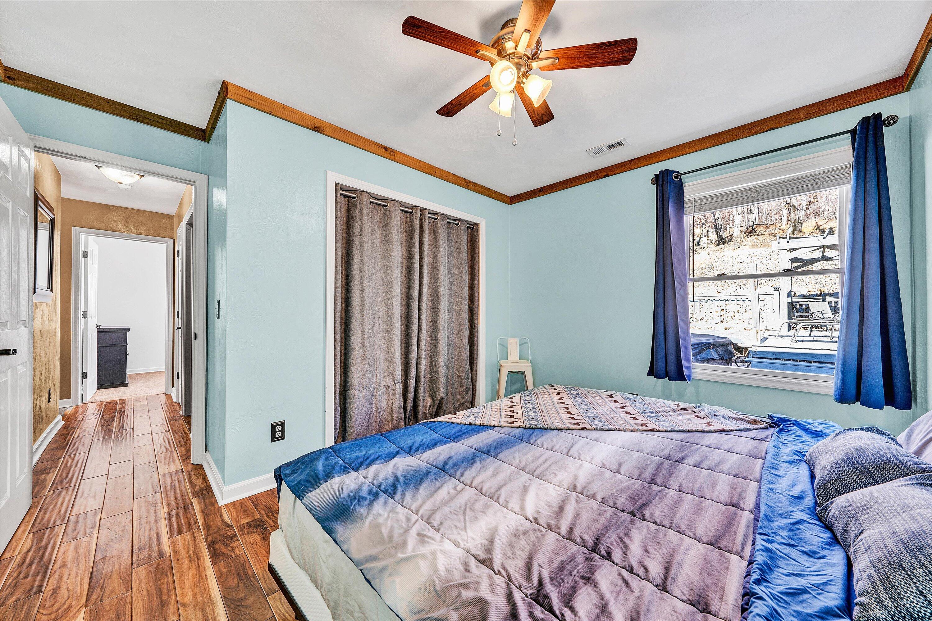 1311 Walnut Shell Drive Vinton, VA 24179 - Photo 32 of 61 a bedroom with a large bed and a chandelier