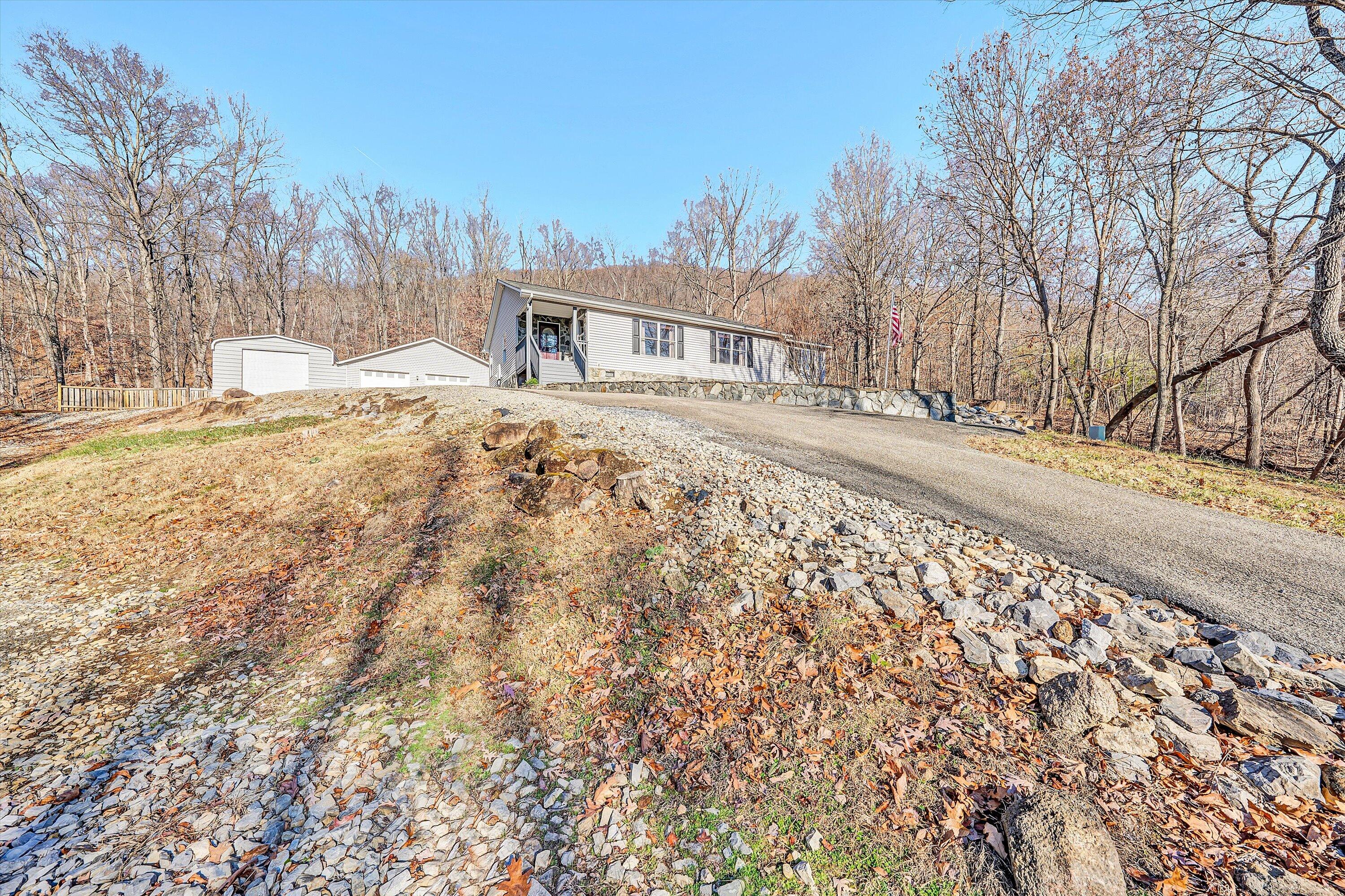 1311 Walnut Shell Drive Vinton, VA 24179 - Photo 46 of 61 a front view of house with yard and trees in the background