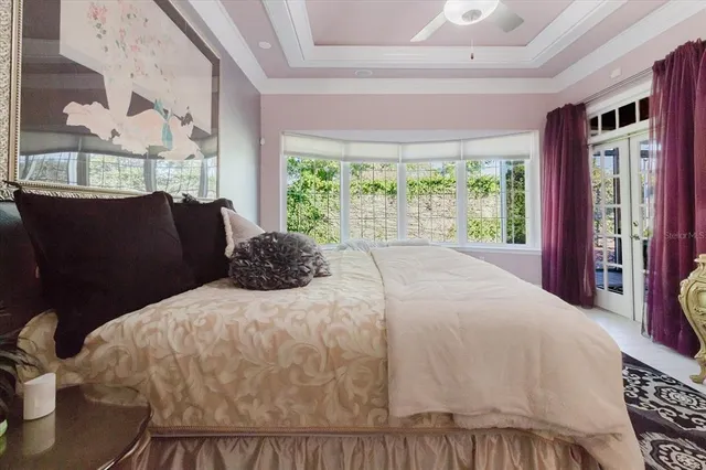 a bedroom with a bed and a chandelier