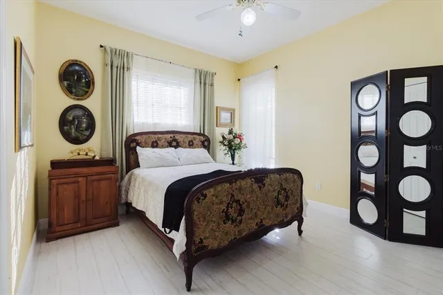 a view of a swimming pool in a yard with palm trees