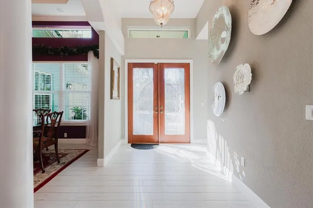 a view of a dining room with furniture and a chandelier