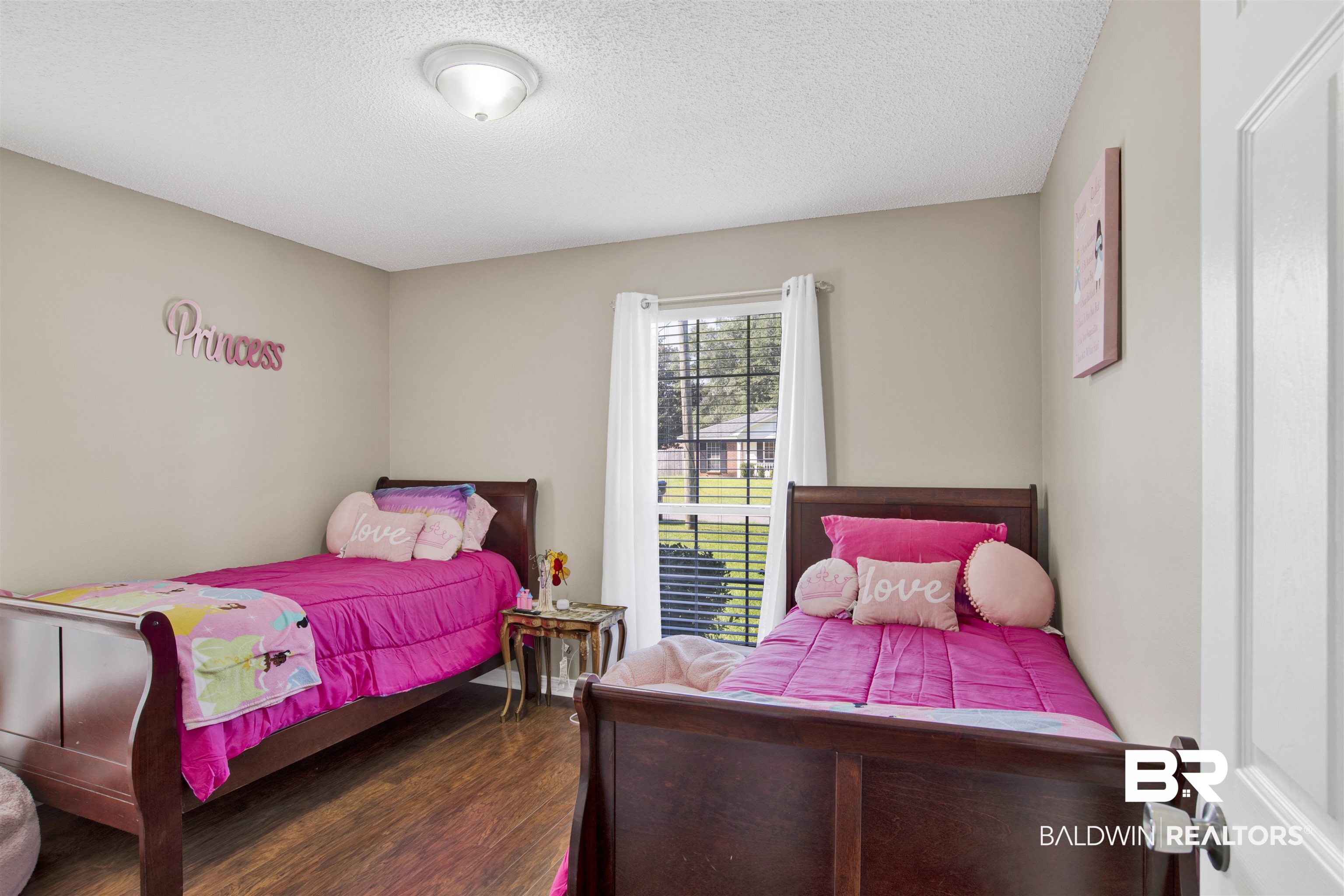 6281 Woodside Drive Theodore, AL 36582 - Photo 13 of 17 Bedroom featuring wood finished floors and a textured ceiling