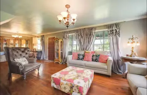 a living room with furniture and a chandelier