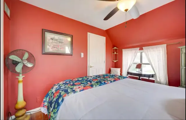 a bedroom with a bed and a window