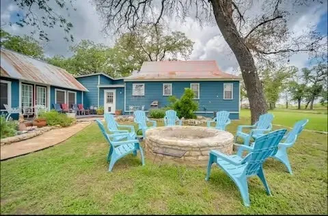 a view of a patio with table and chairs and potted plants