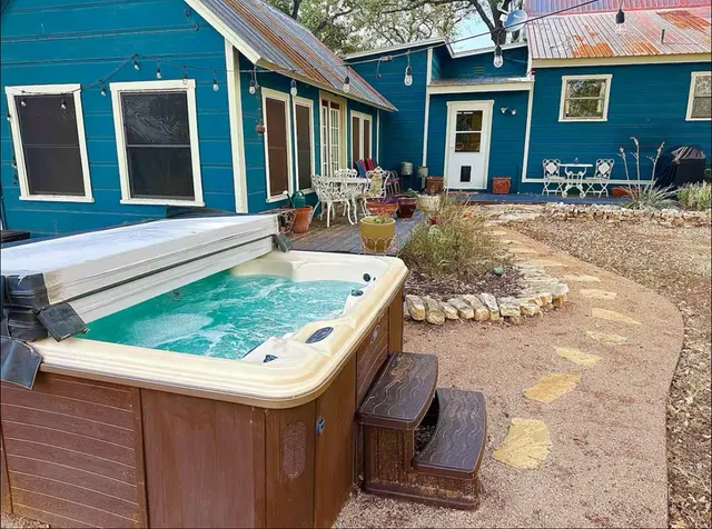 a view of a house with backyard porch and sitting area