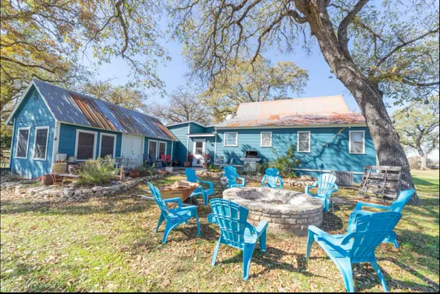a view of a house with backyard porch and sitting area