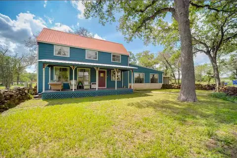 a view of a house with swimming pool next to a big yard
