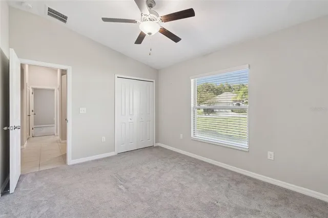a view of a livingroom with a ceiling fan and window