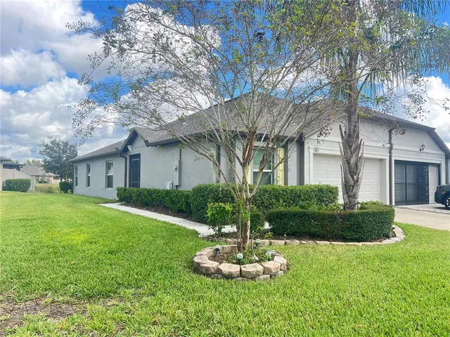 a front view of house with a garden