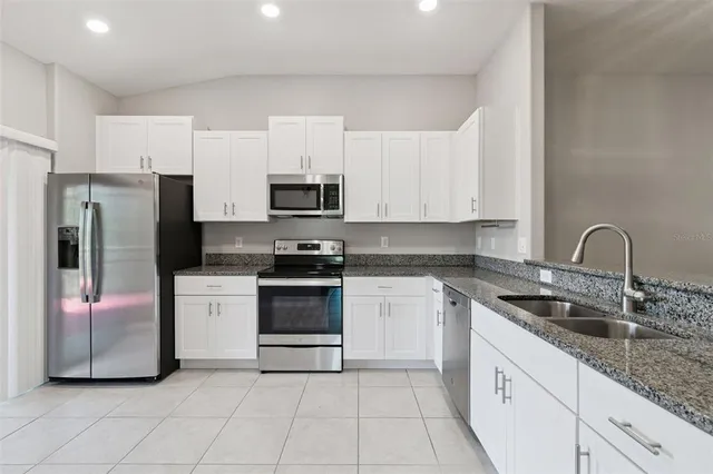 a kitchen with a sink and white cabinets