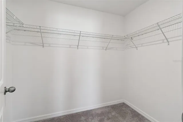 a bathroom with a granite countertop sink toilet and mirror