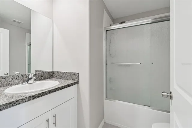 a white toilet sitting next to a shower