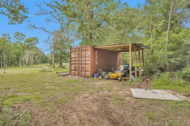 a dining room with wooden floor and chandelier