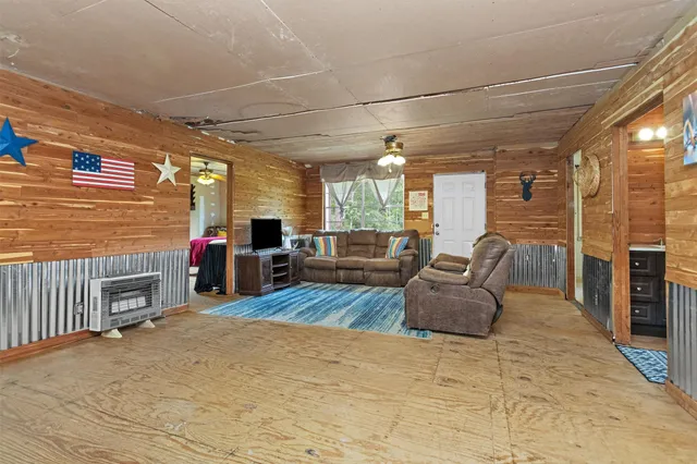 a bedroom with furniture and large windows